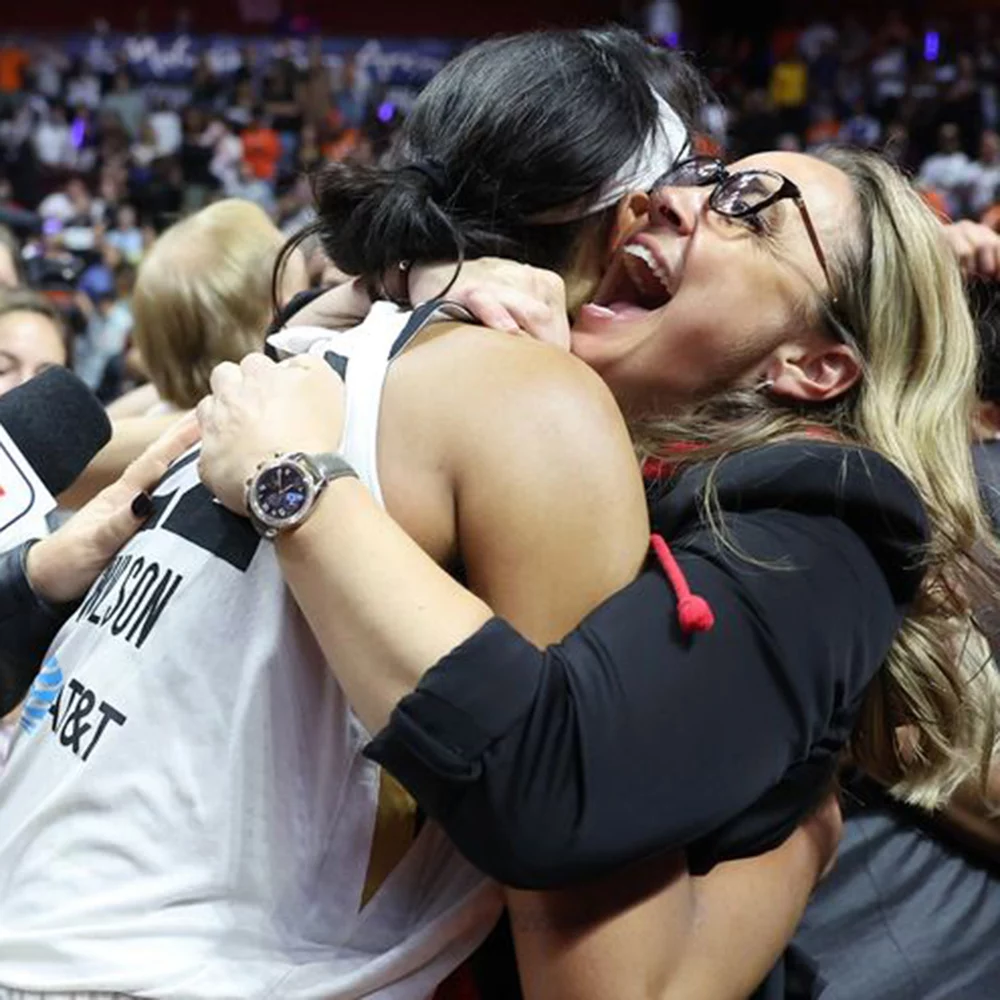 Becky Hammon celebrates with a member of the Las Vegas Aces