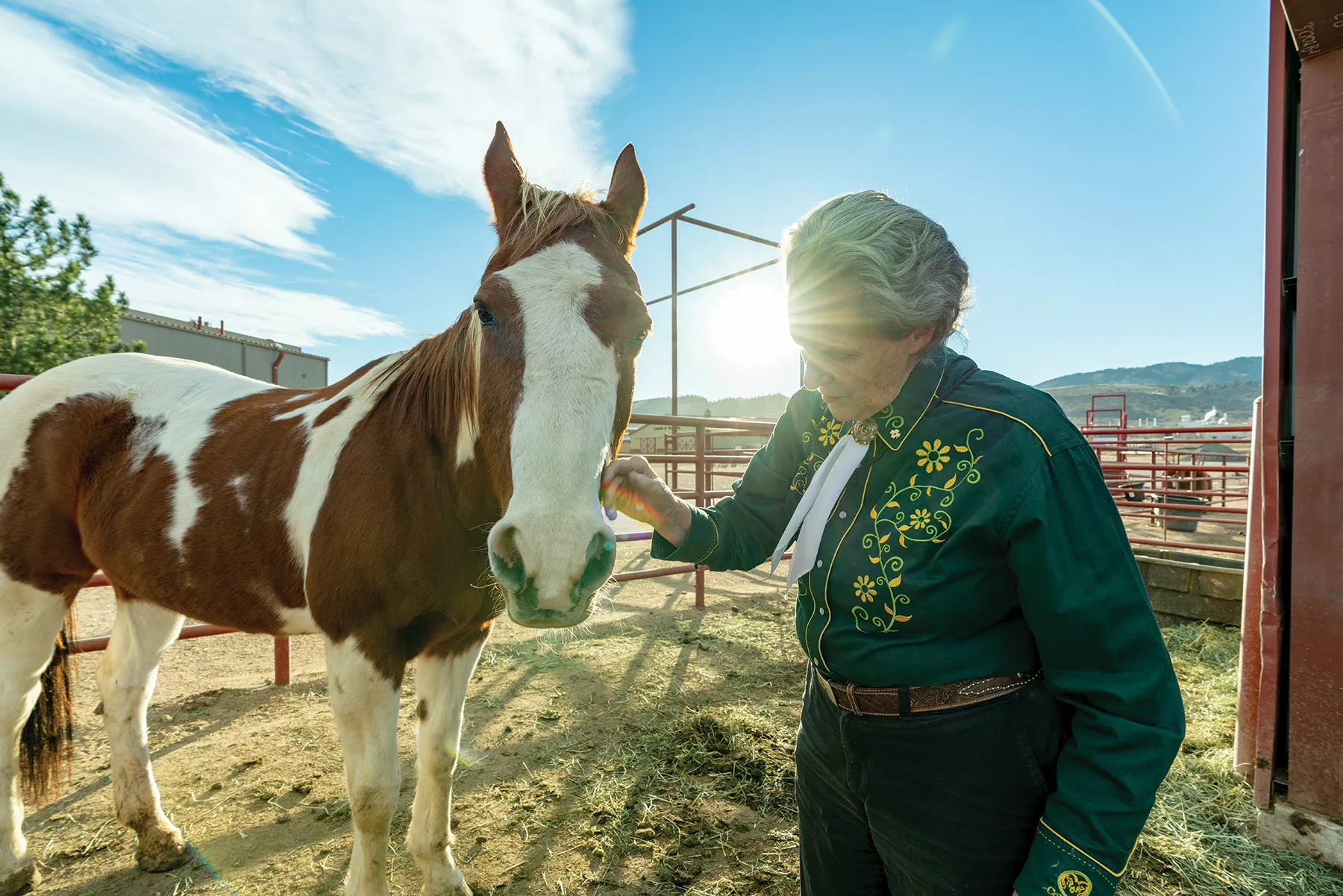 Temple Grandin with a brown and white horse