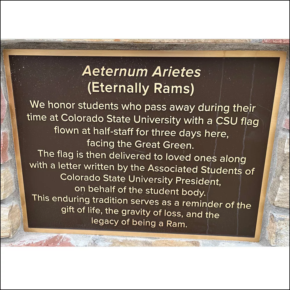 Bronze plaque explaining why the CSU flag flies at half-staff for students who have died.